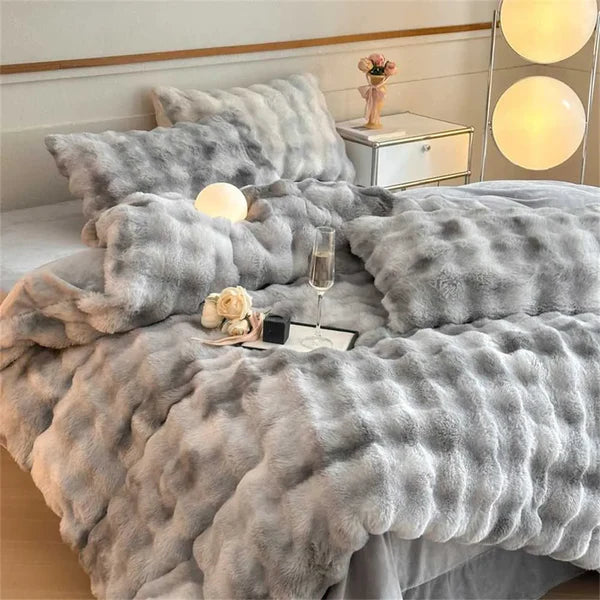 Cobija premium piel de conejo en cama